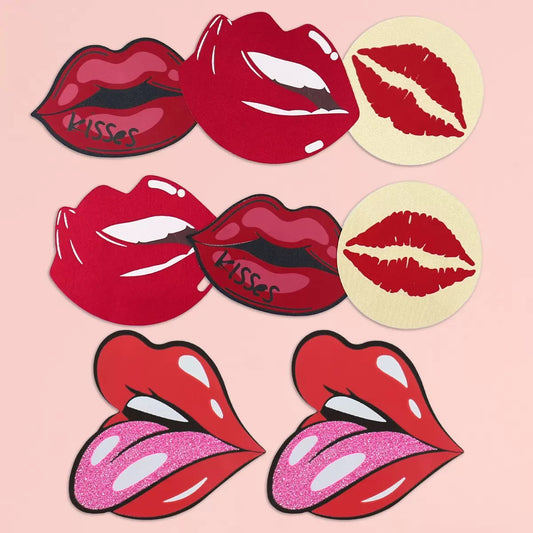 A pair of playful red lip-shaped nipple pasties featuring the word 'Kisses' in bold black script. Designed for a fun and flirty look, these adhesive covers are perfect for lingerie styling, burlesque performances, or intimate wear.